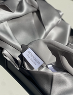 Serenquor 100% Mulberry Silk Pillowcase in Silver featuring brand label, care instructions and 22 Momme Grade 6A silk fabric