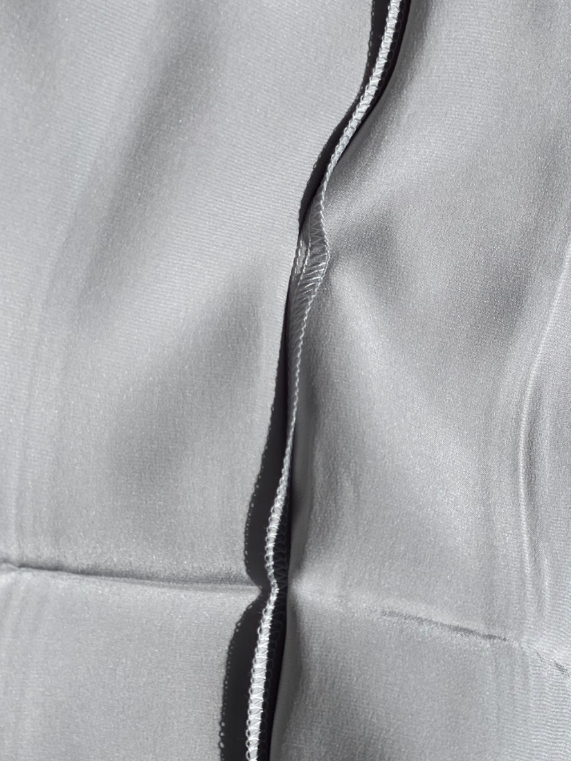 Close up of the inner stitching on a Serenquor 100% Mulberry Silk Pillowcase in Silver showing premium craftsmanship and durable construction