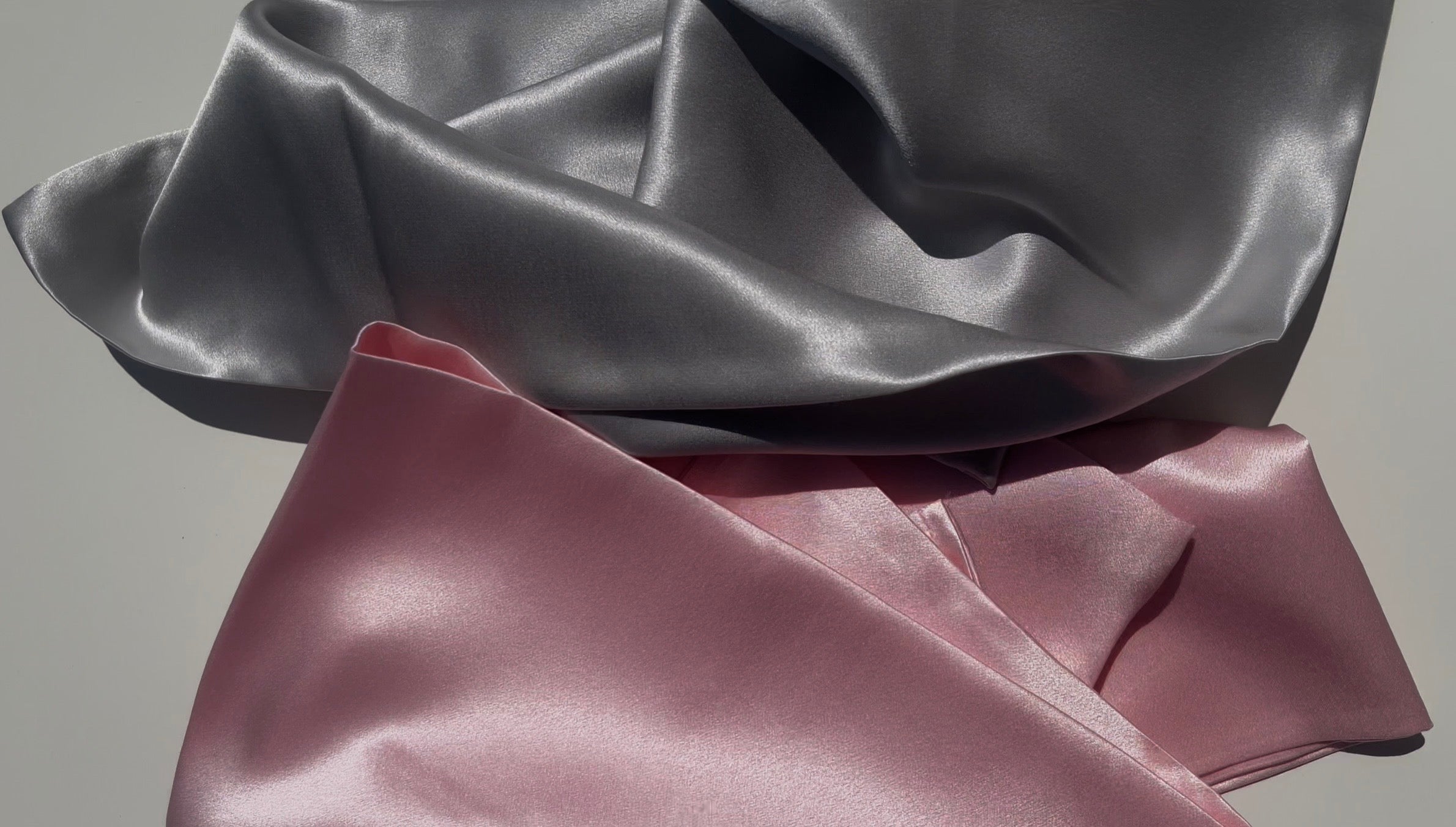 Luxury 22 momme 100% Mulberry silk pillowcases in pink and silver designed for healthier hair smoother skin and comfortable sleep made in Germany